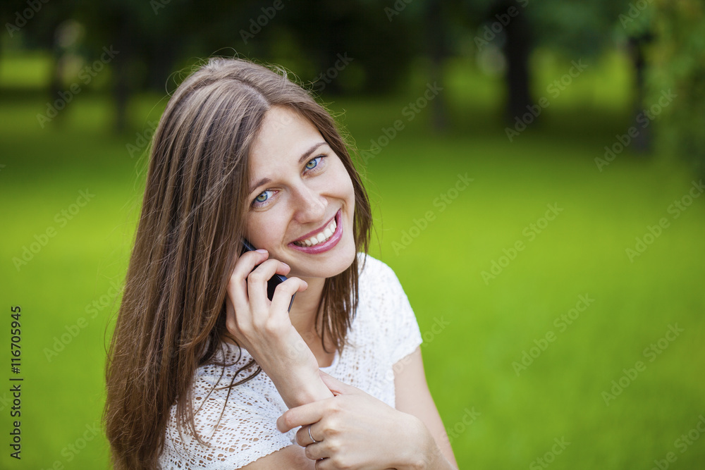 Portrait of beautiful dark haired young woman speaking on mobile Portrait of beautiful dark haired young woman speaking on mobile