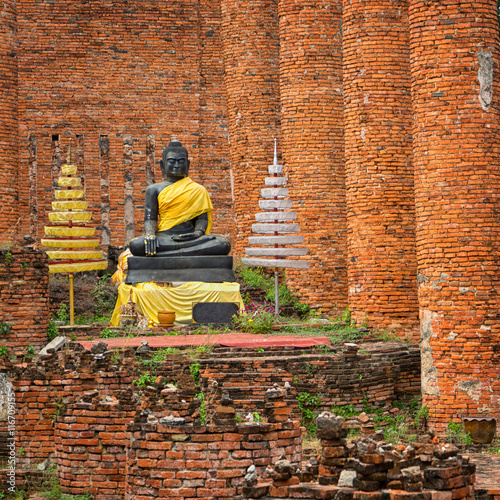 Old Buddha statue in temple ruin. Ayuthaya, Thailand photo