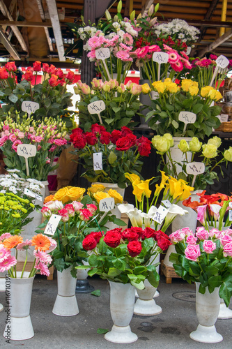 Offer fresh cut flowers with price tags in the shop market