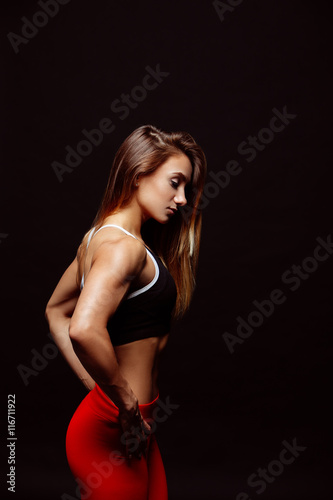 Muscular body of a young woman, abs close up. Woman's abs