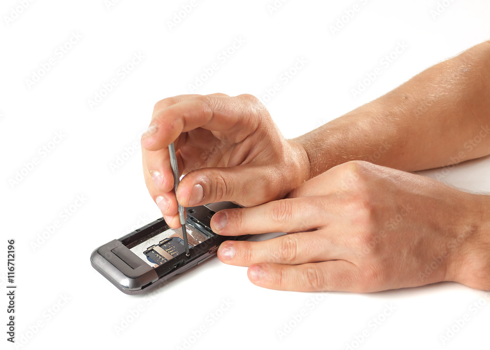 Male hands apart the phone for repair