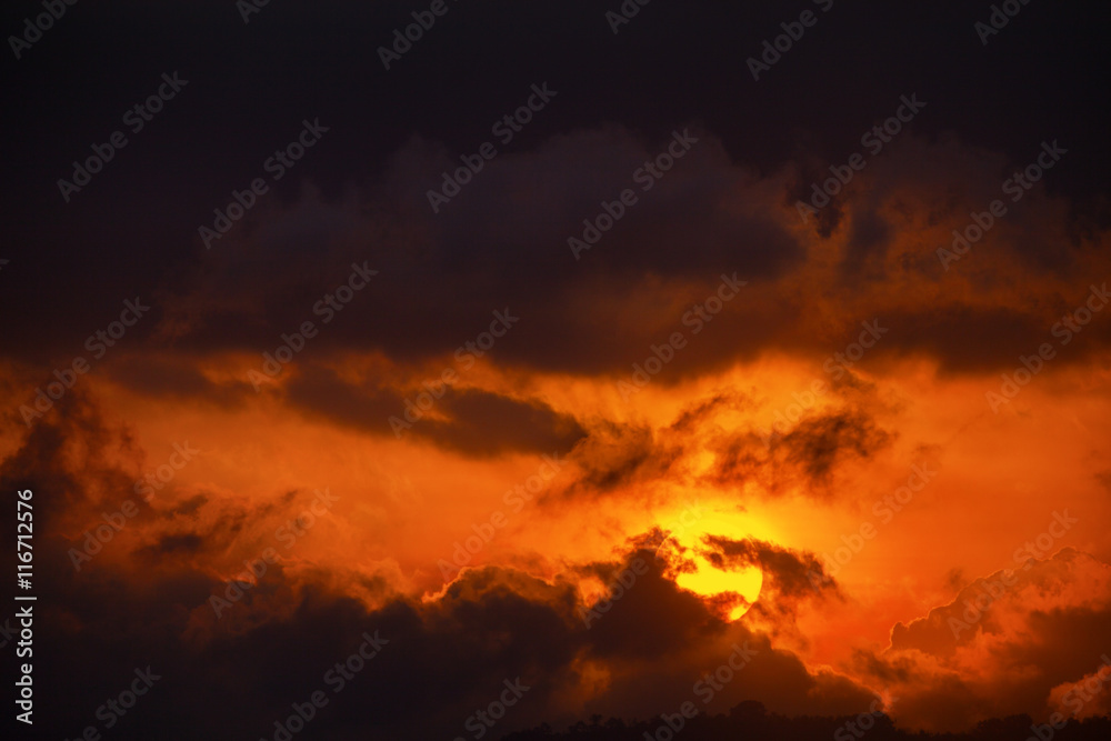 Sun's Last Orange Rays through the Clouds at Dusk