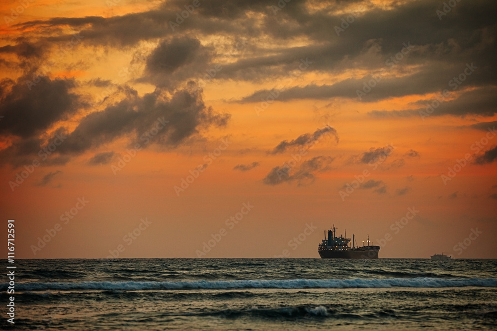 Enormous Tanker Ship on the Horizon at Sunset