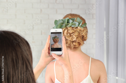 Taking photo of young woman...