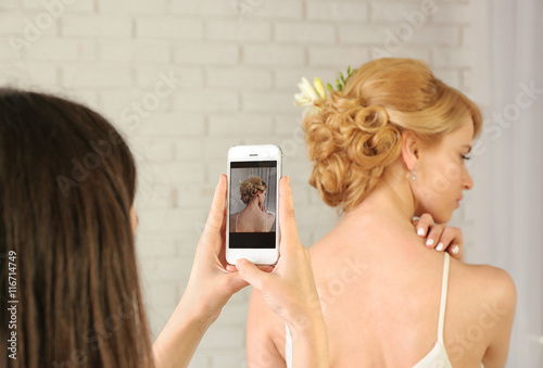 Taking photo of young woman...