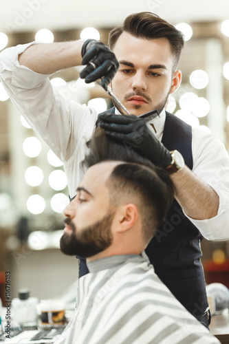 Barber doing haircuts for client