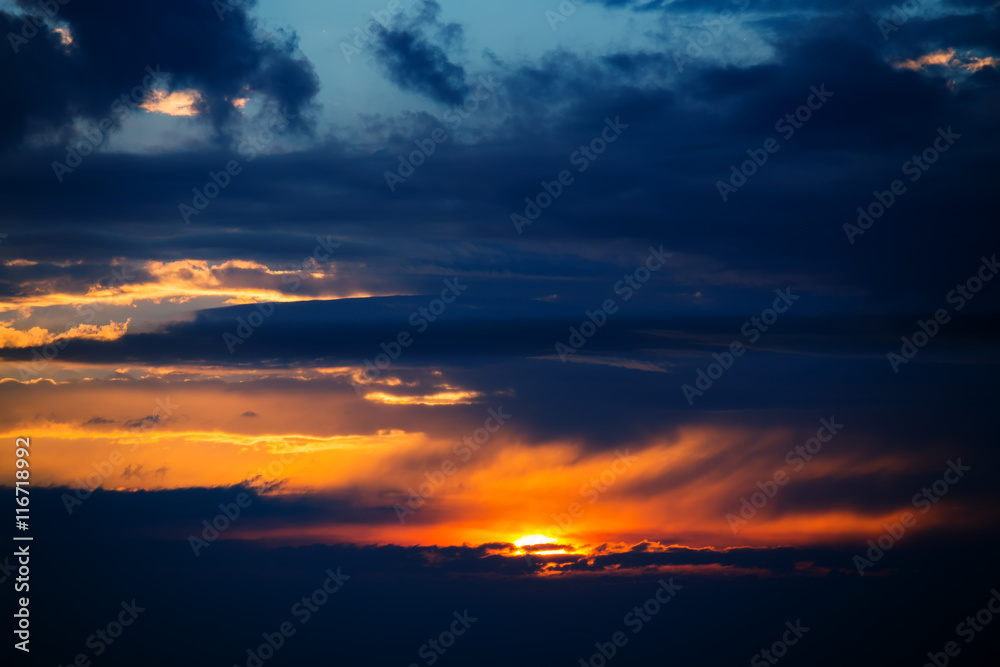 Photo of dramatic sunset with dark clouds