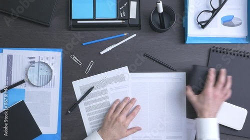 Corporate businessman tidying up his messy desktop, efficiency and organization concept, top view