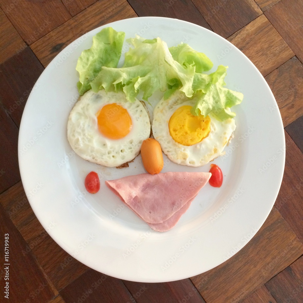 Creative funny breakfast, top view BLT braakfast on the wooden table with light Creative funny breakfast, top view BLT braakfast on the wooden table with light