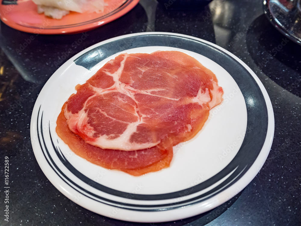 Pork on plates for suiyaki or shabu-shabu, shallow DOF, selective focus