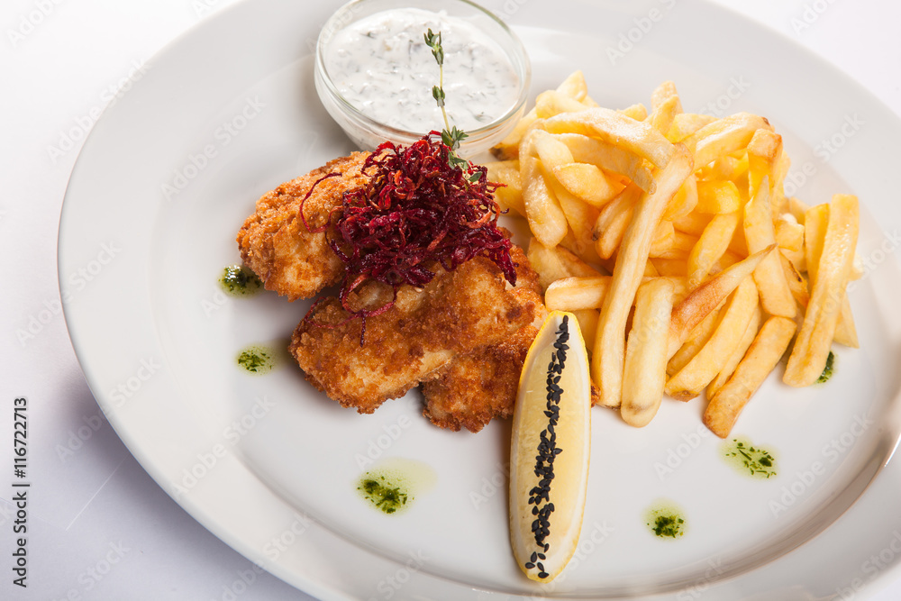 dish of meat in batter and fried potatoes dish of meat in batter and fried potatoes