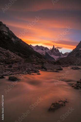 View of river with snow covered mountain during sunset