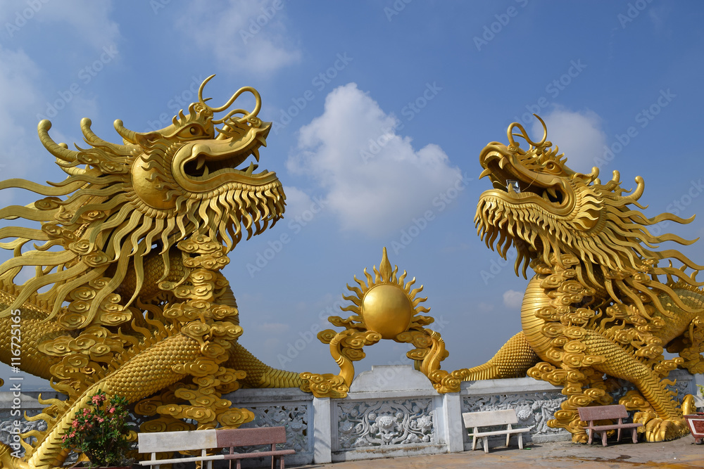 two big statue of golden dragon at Buddhist Chau Thoi temple, Binh Duong, Vietnam