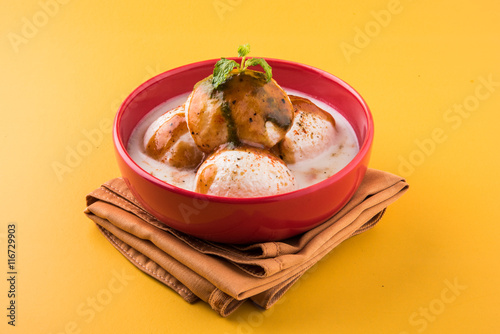 dahi vada or dahi vade also known as Curd Vadai in South India, a popular snack famous all over India prepared by soaking lentil vadas in thick dahi or yogurt, topped with spicy & sweet chutney etc photo