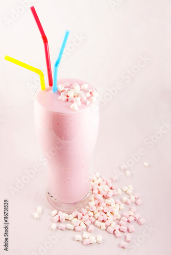 Milkshake with bright straws and marshmallow