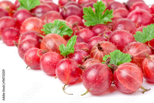 red gooseberries with leaves isolated on white background