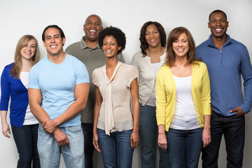 Group of diverse people outside smiling.