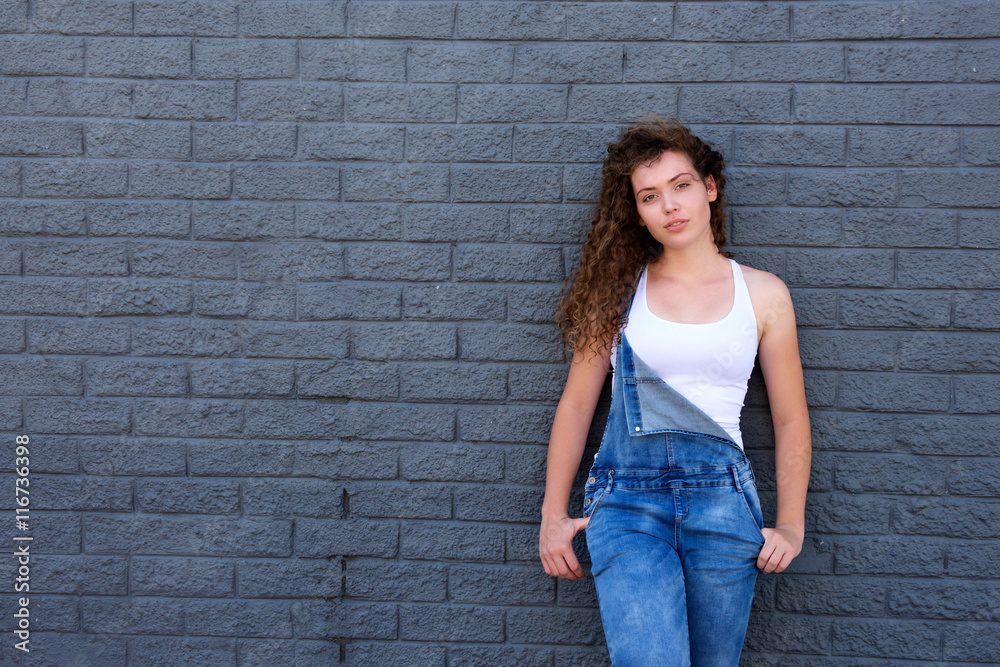 Teen girl with attitude standing with hands in pockets