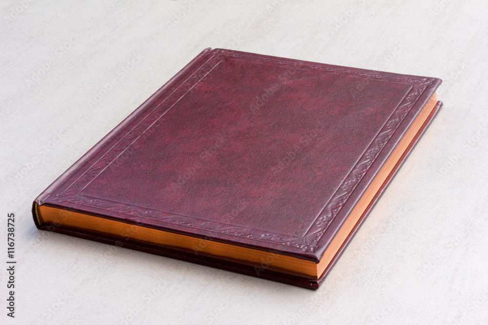 purple book with gold pages on the gray background close-up purple book with gold pages on the gray background close-up