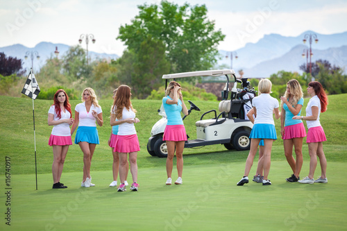 Group of young golf caddies hanging out on golf course