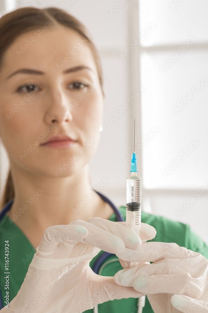 Medical doctor with syringe. Young female nurse with syringe Medical doctor with syringe. Young female nurse with syringe