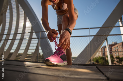 Woman runner tying shoe laces