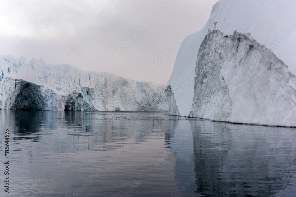 Icebergs are on the arctic ocean on sunset time with shadow Icebergs are on the arctic ocean on sunset time with shadow