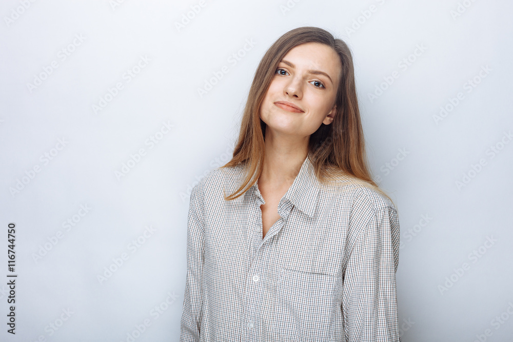 Portrait of happy young beautiful woman in big shirt posing against white studio background Portrait of happy young beautiful woman in big shirt posing against white studio background
