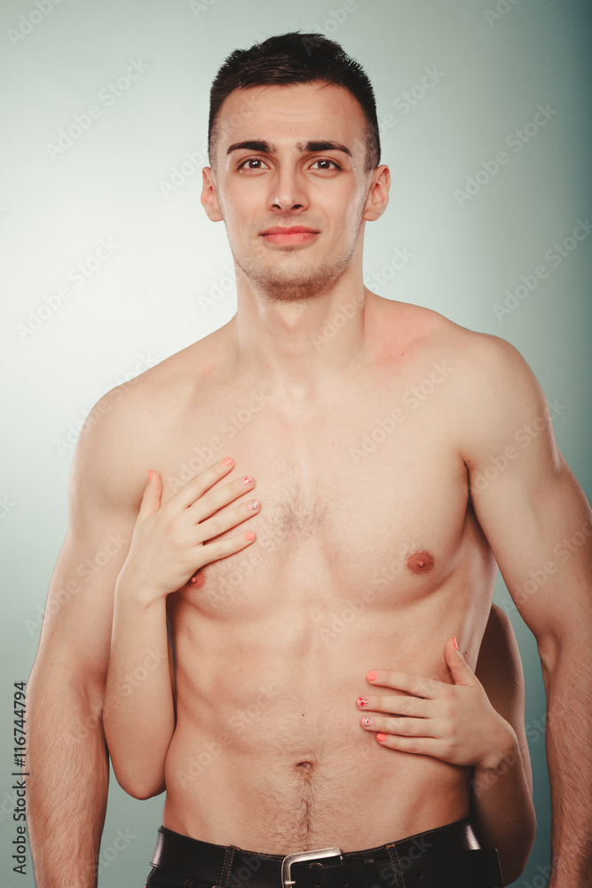 Fototapeta premium Sexy couple. Woman hands embracing half naked man.