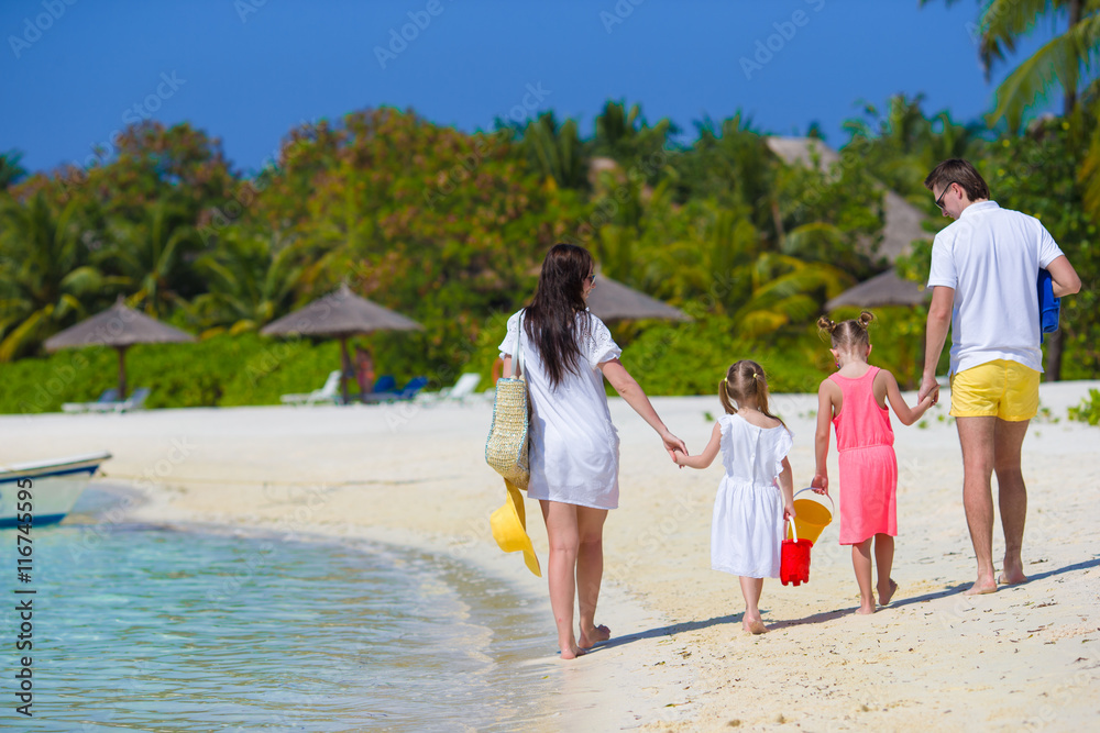 Happy beautiful family on white beach vacation