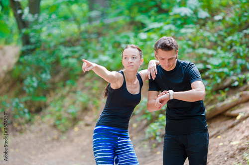 Fototapeta Naklejka Na Ścianę i Meble -  Fitness healthy lifestyle of young couples training for marathon run outside in park