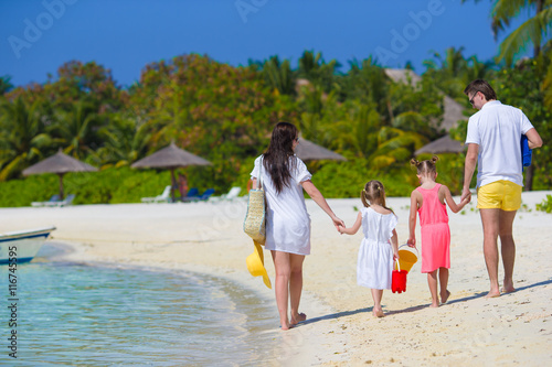 Happy beautiful family on white beach vacation