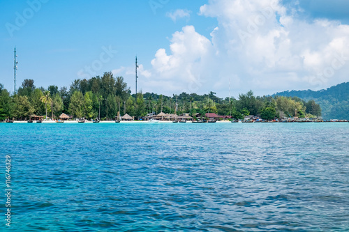 Island blue indigo sea with resort on beach, most abundant coral reef at lipe island,thailand