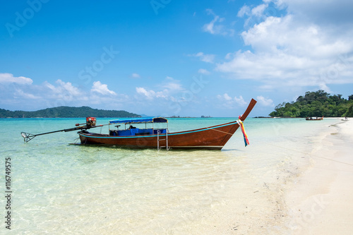 Long tail wooden boat anchor with csytal sea white sand at lipe island,andaman,thailand © Mumemories