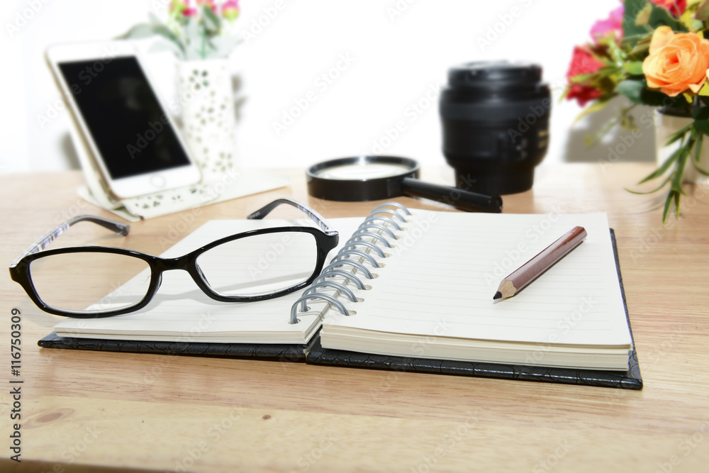 Open Blank notebook and pencil with magnifying glasses and Open Blank notebook and pencil with magnifying glasses and