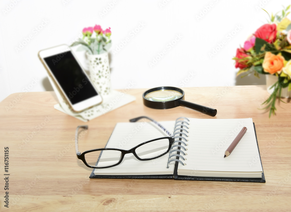 Open Blank notebook and pencil with magnifying glasses and Open Blank notebook and pencil with magnifying glasses and