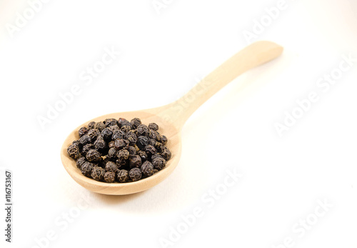 salt and pepper in a wooden spoon. Isolated on white background.