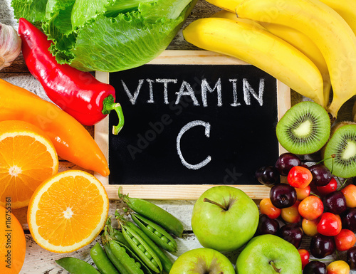 Foods High in vitamin C on a wooden board.