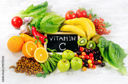 Foods High in vitamin C on wooden board.