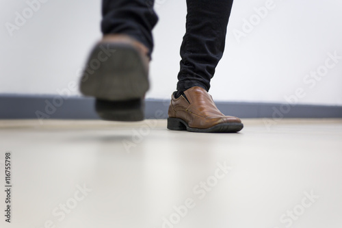 Half leg of man Walking in the office 