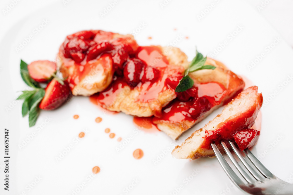 Pancake strawberry dessert with fork on white background, copyspace. Sweet flapjacks with berry topping eating Pancake strawberry dessert with fork on white background, copyspace. Sweet flapjacks with berry topping eating