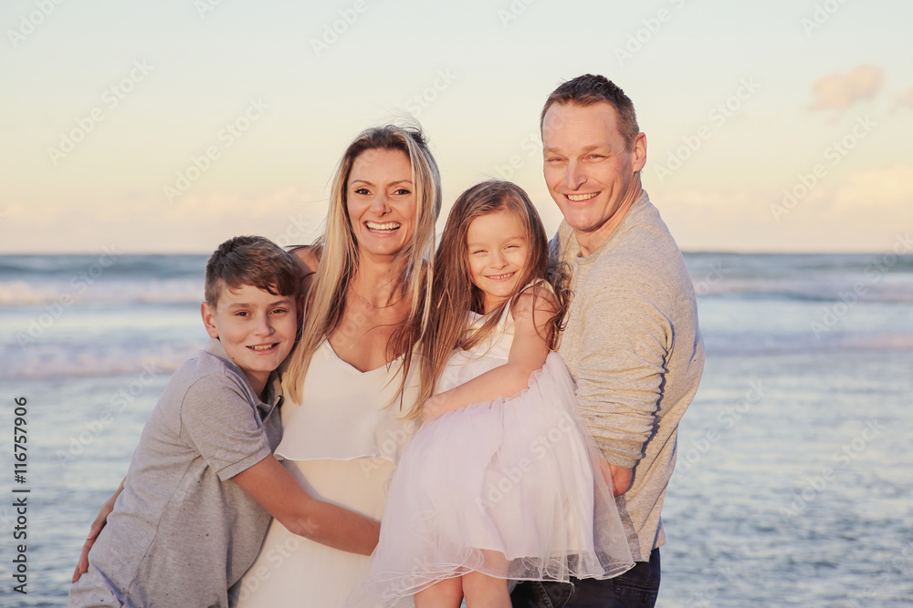 Happy Family of four portrait on the beach, toning