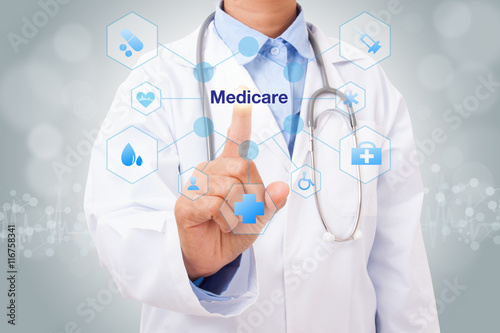 Doctor hand touching medicare sign on virtual screen. medical concept photo