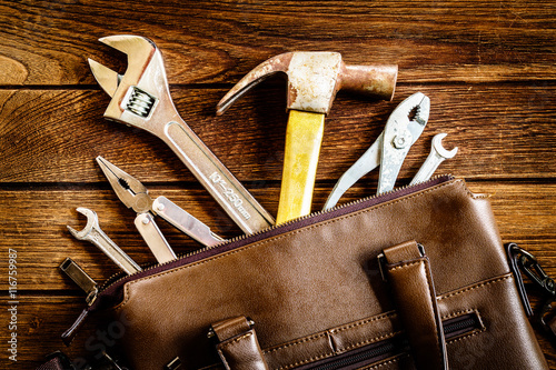 tools in leather bag - labor day and business fight background c