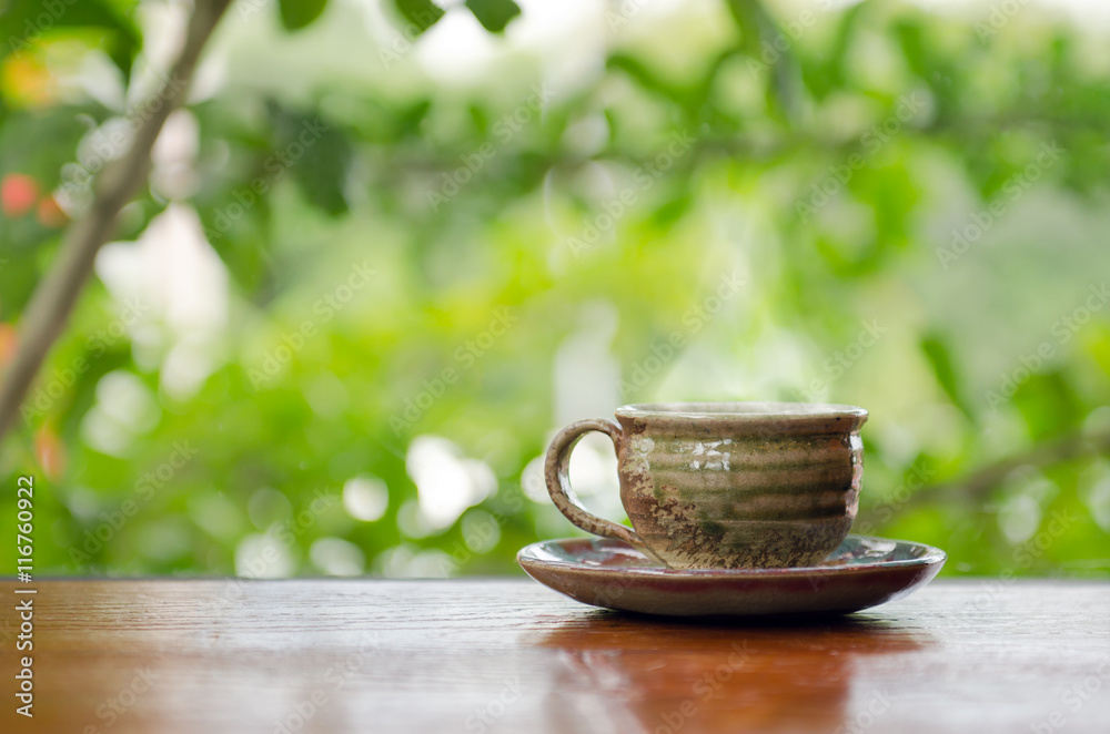 Hot coffee cup on the wooden table in coffee shop Hot coffee cup on the wooden table in coffee shop