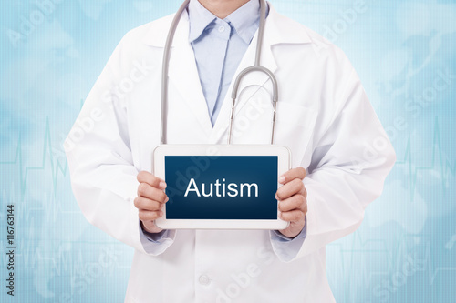 Doctor holding a tablet pc with hemorrhoid sign on blue background photo