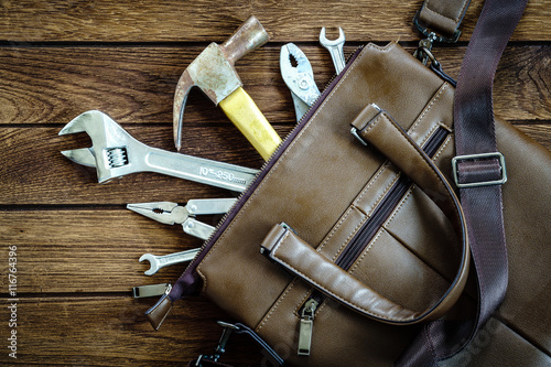 tools in leather bag - labor day and business fight background c
