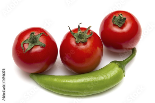 Green hot peppers and red tomatoes