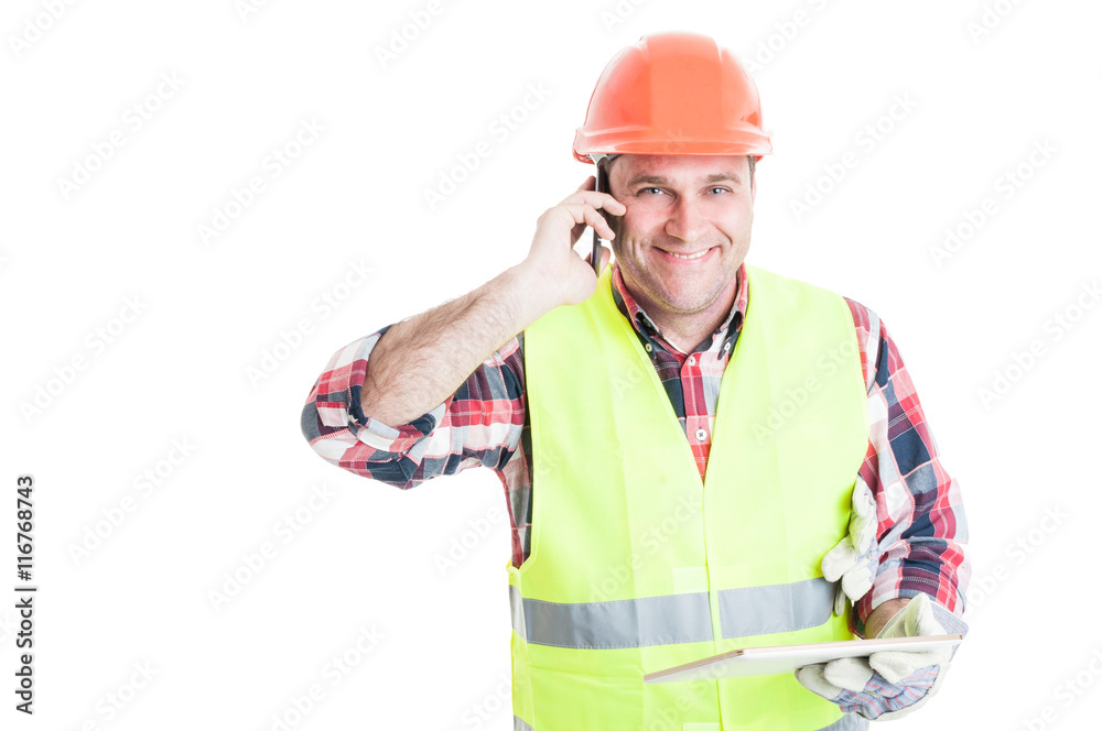 Handsome builder holding tablet and calling somebody Handsome builder holding tablet and calling somebody