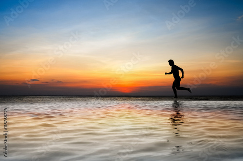 silhouette of man running on the beach